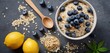  .The image features a bowl filled with granola and blueberries. There are several blueberries scattered throughout the bowl, adding color and.