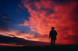 Abstract interpretation of a cowboy's silhouette with a vibrant sky.