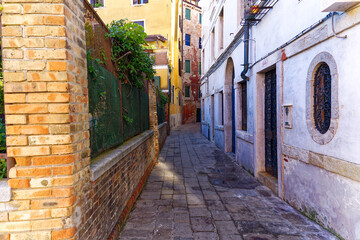 Naklejka na meble Old town of Italian City of Venice with alley with colorful weathered facades on a summer day. Photo taken August 6th, 2023, Venice, Italy.