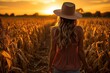 © Anat art - Woman in cornfield, back view, Girl is standing in the field and holding her hands out while looking at sun. We can see rays of sun. There is a big cornfield behind the girl. Generative AI