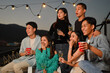 © Prathankarnpap - Cheerful male and female friends laughing and having fun at rooftop party. Friendship lifestyle concept.