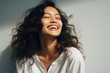 © Synthetica - Portrait of a beautiful young woman with long curly hair smiling .