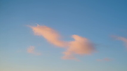 Wall Mural - Sunset clouds illuminated by the orange setting sun, timelapse