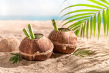 Fresh coconut milk in shell on an resort island.