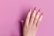elegant nail design. a woman's hand with a lilac manicure in close-up.