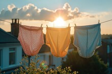 Vintage Pastel-colored Women's Knickers Hang On A Rack Against A Clear Blue Sky, Basking In The Warm Sunshine.