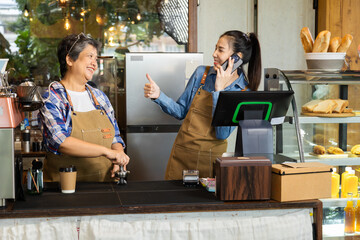 Wall Mural - Two baristas female 60s senior mother and daughter happy making decision open cafe coffee shop small business startup after retirement, family relationship in eatery business working bonding together