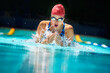 Sports, water splash or woman in swimming pool for competition training, workout or energy. Fitness, breathing or cardio with female swimmer and athlete for exercise, championship and race at gala