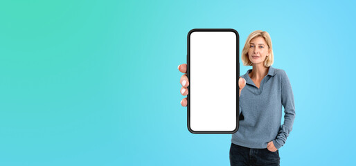 cheerful woman showing phone with blank screen