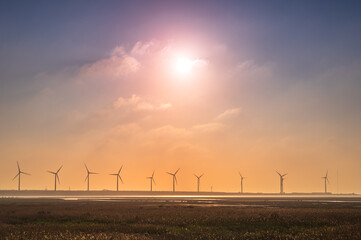 Offshore wind farms are great for enjoying the scenery and watching the sunset. Gaomei Windmill Avenue. Taichung Harbor Wind Power Station. Taiwan.