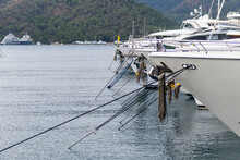 Row Of Super Yachts Moored In Marina Fore Side View. Mediterranean Yacht Port With Sailing Boats. Yachting Concept.