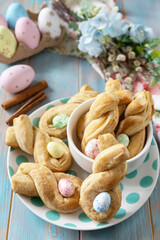Wall Mural - Easter rabbit-shaped buns puff pastry with  cinnamon on a wooden blue tabletop.