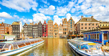 Amsterdam City Skyline And Dancing Houses Over Damrak Canal, Netherlands