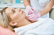 © Svitlana - Side view of cosmetologist doing face beauty injection with syringe of woman