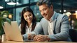 © Fanni Art - A picture of beautiful couple businessman and businesswoman sitting in office and working on laptop Generative AI