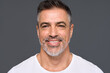© insta_photos - Happy confident handsome healthy mature older man, smiling middle aged male model wearing white t-shirt standing isolated on gray background advertising skin care and dental smile concept.