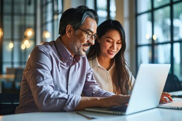 Two happy diverse professional colleagues Latin business man and Asian woman corporate executives working together in office using laptop, talking, Generative AI