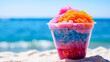 Chill vibes by the beach. Frozen ice adorned with colorful fruits in a cup, creating a refreshing and tropical summer sensation.