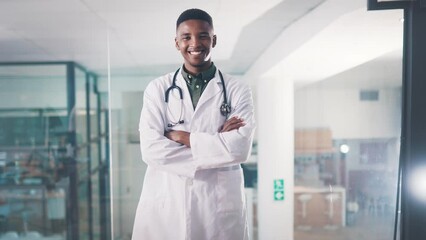 Poster - Black man, doctor and arms crossed in hospital, confident or employee for healthcare, young or smile. Medicare, happy and professional in medical career, job or asian person for medicine or worker