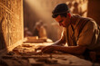 young egyptian man working on ancient relief with hieroglyphs