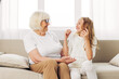 © SHOTPRIME STUDIO - Girl happy family couch grandmother granddaughter home child sofa love