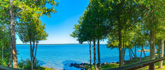 View from house on the island lake, view from cottage or villa balcony in Manitoulin Island. Sunny summer day at Lake Manitou, Ontario, Canada. Famous Canadian tourist vacation routs. North America.