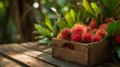 Fresh rambutan in a box on a wooden background, nature