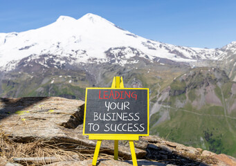Wall Mural - Leading business to success symbol. Concept words Leading your business to success on beautiful blackboard. Beautiful mountain Elbrus background. Leading your business to success concept Copy space