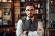 © Darya Lavinskaya - Handsome Caucasian bearded man wears suit and glasses standing in barbershop with crossed hands