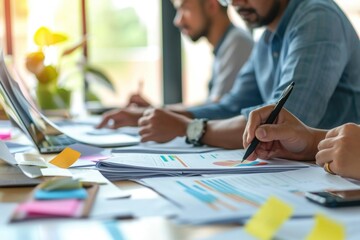 Aufkleber - A group of people sitting at a table, all focused on their laptops. Ideal for illustrating teamwork, collaboration, or a modern office environment