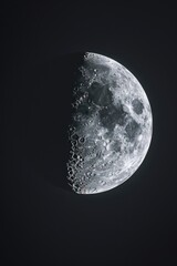 Poster - A close-up view of the moon against a black background. Perfect for astronomy enthusiasts or for creating a mysterious atmosphere
