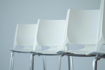 Aufkleber - A row of white chairs lined up next to each other. Perfect for seating arrangements or event settings