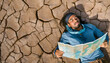 © williamlacruz - lost man looks at a map in the dry sandy desert without water