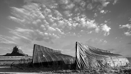 Wall Mural - Stunning dramatic  black and white landscape image of Lindisfarne, Holy Island in Northumberland England during Winter