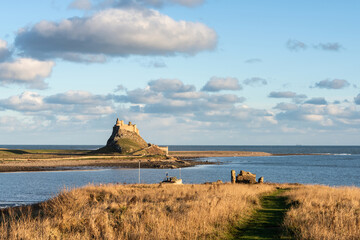 Wall Mural - Stunning dramatic landscape image of Lindisfarne, Holy Island in Northumberland England during Winter