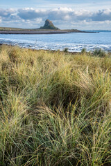 Wall Mural - Stunning dramatic landscape image of Lindisfarne, Holy Island in Northumberland England during Winter