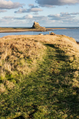 Wall Mural - Stunning dramatic landscape image of Lindisfarne, Holy Island in Northumberland England during Winter