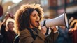 Young woman speaking through a megaphone at a protest