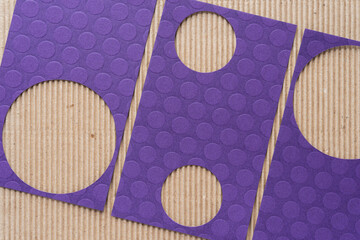 Canvas Print - abstract paper background featuring purple cards with circle cutouts on brown corrugated cardboard paper