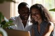 © Konstiantyn Zap - Amid a home office setting, a couple in business attire exchanges smiles, finding delight in the laptop screen's contents, fostering a positive atmosphere