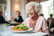 An elderly woman is enjoying her salad in a restaurant