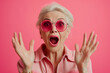 woman wearing business clothes and glasses looking fascinated with disbelief, surprise and amazed expression. Surprised Mature Woman with Glasses with Big Hair on an Pink Background