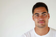 © Margaret - Portrait of a Young Man Smiling Against a White Background in Natural Light