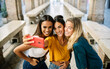 © Xavier Lorenzo - Young happy group of multiracial best women friends taking selfie portrait on cellphone app during summer vacation in Italy. Youth, travel and female friendship concept