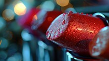  A Close Up Of A Red Fire Hydrant With Drops Of Water On It And A Blurry Boke Of Lights In The Back Ground Behind The Hydrant.
