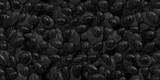 Fototapeta Natura - Seamless dark black pile of small stone pebbles background texture. Beautiful shiny zen gravel river rocks widescreen wallpaper repeat pattern. High resolution nature closeup abstract 3D rendering.