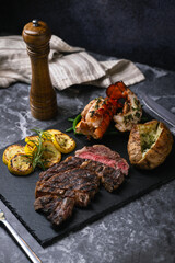 Wall Mural - surf and turf, ribeye steak and lobster tail on black marble background
