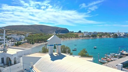 Wall Mural - White color greek church and blue water of sea in island of Cyclades