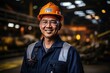 Portrait of a smiling Asian male engineer wearing a hard hat in a factory