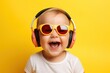 Portrait of cheerful happy boy / girl wearing headphones listen to music dance isolated on yellow background, Generative AI